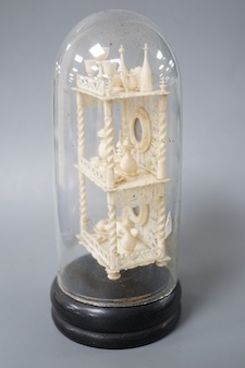 A Victorian ivory model of objects on a whatnot, under a glass dome 16cm